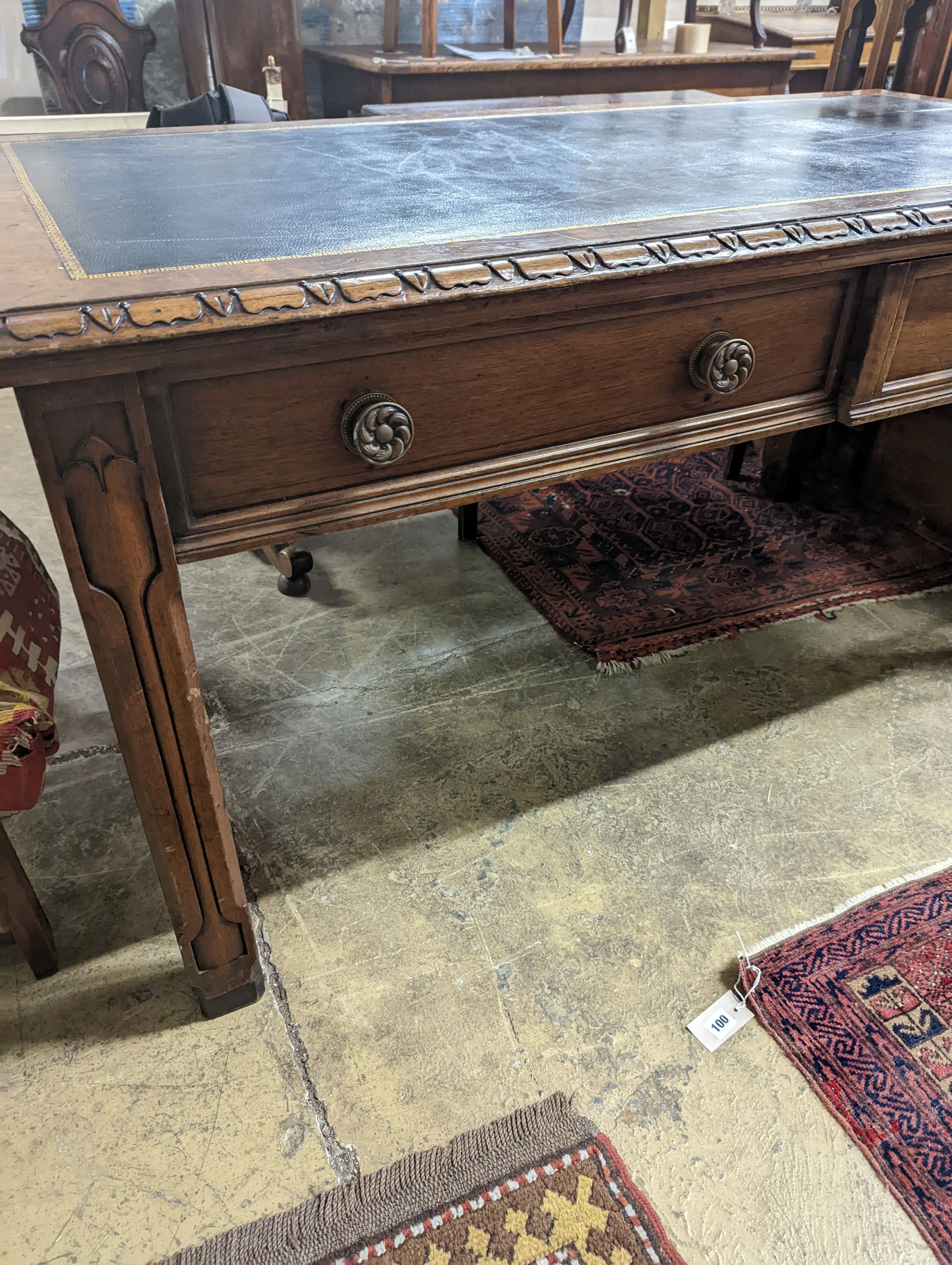 A Victorian Gothic style walnut two drawer library table, width 152cm, depth 78cm, height 76cm